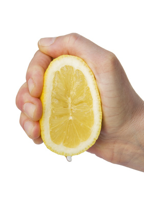 hand squeezing a lemon